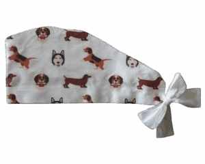White fun disposable scrub caps with cute dog faces and a side bow.