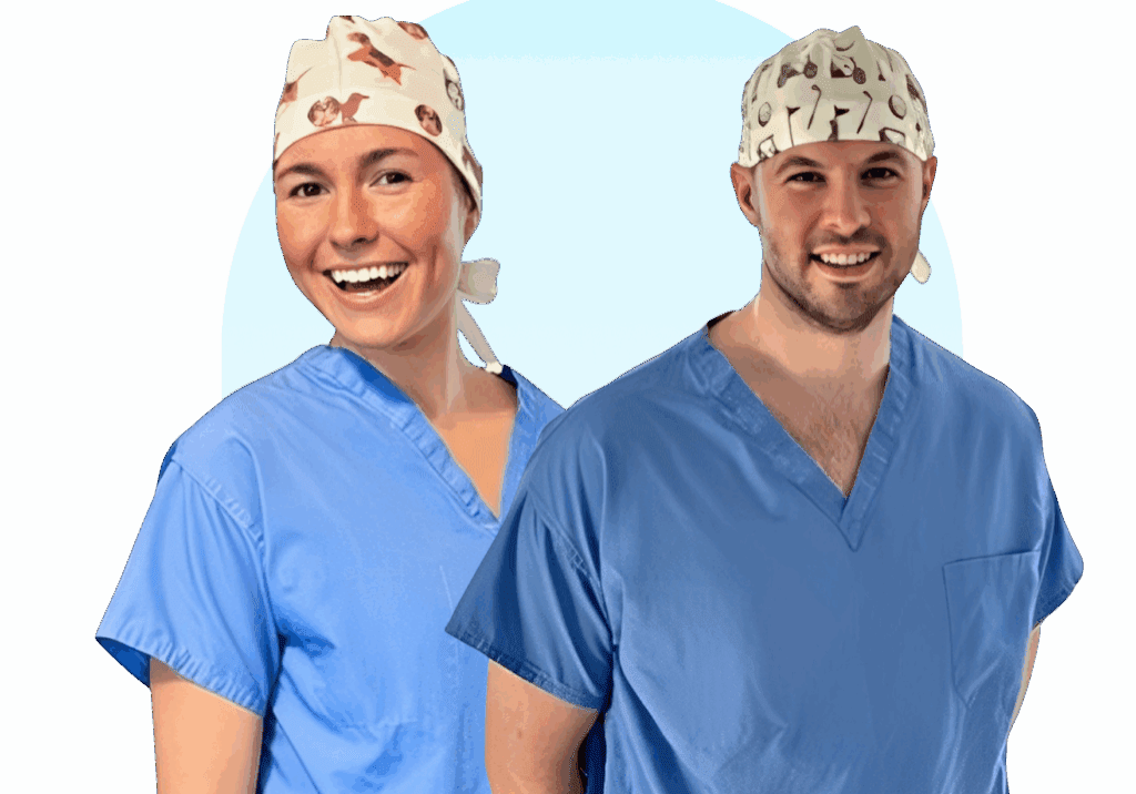 Two medical professionals in colorful surgical caps and scrubs smiling.